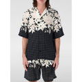Chemise en soie noire à motif de la marque Amiri, détails élégants et tissu luxueux visibles sur l'image.
