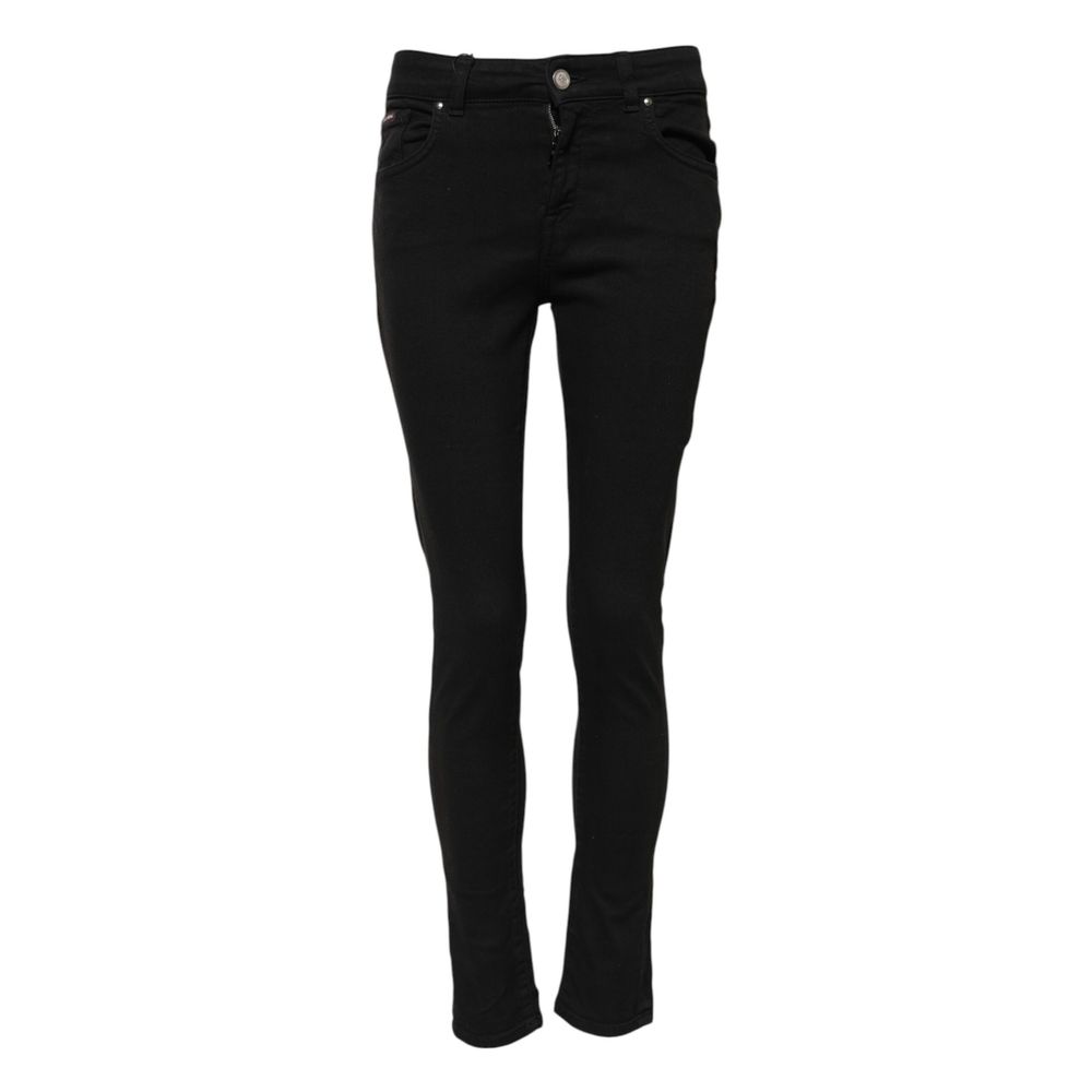 Jeans skinny en coton noir de Dolce & Gabbana, ajustés, avec détails modernes, portée sur un mannequin.