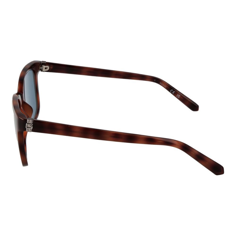 Lunettes de soleil en plastique marron de marque Guess avec monture élégante et design moderne.