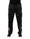 Pantalon chino noir à fleurs Dolce & Gabbana avec coupe droite, tissu élégant et motifs floraux visibles sur l'image.