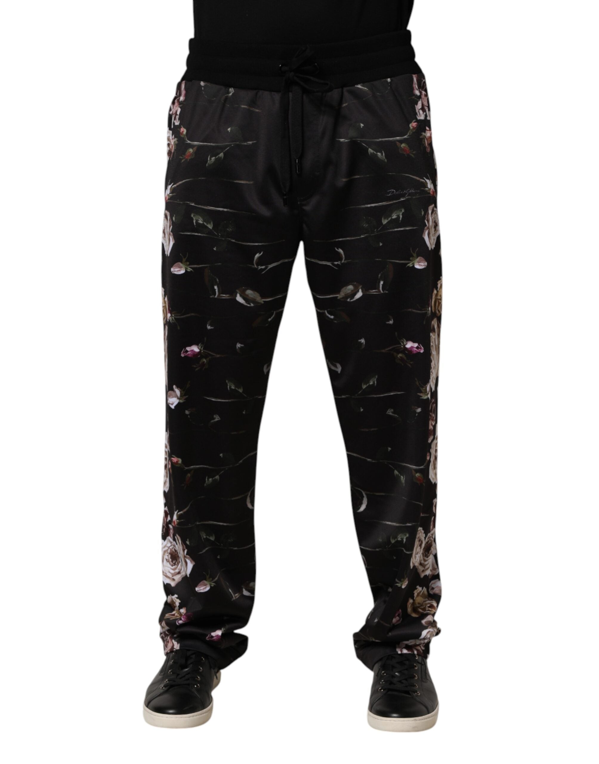 Pantalon chino noir à fleurs Dolce & Gabbana avec coupe droite, tissu élégant et motifs floraux visibles sur l'image.