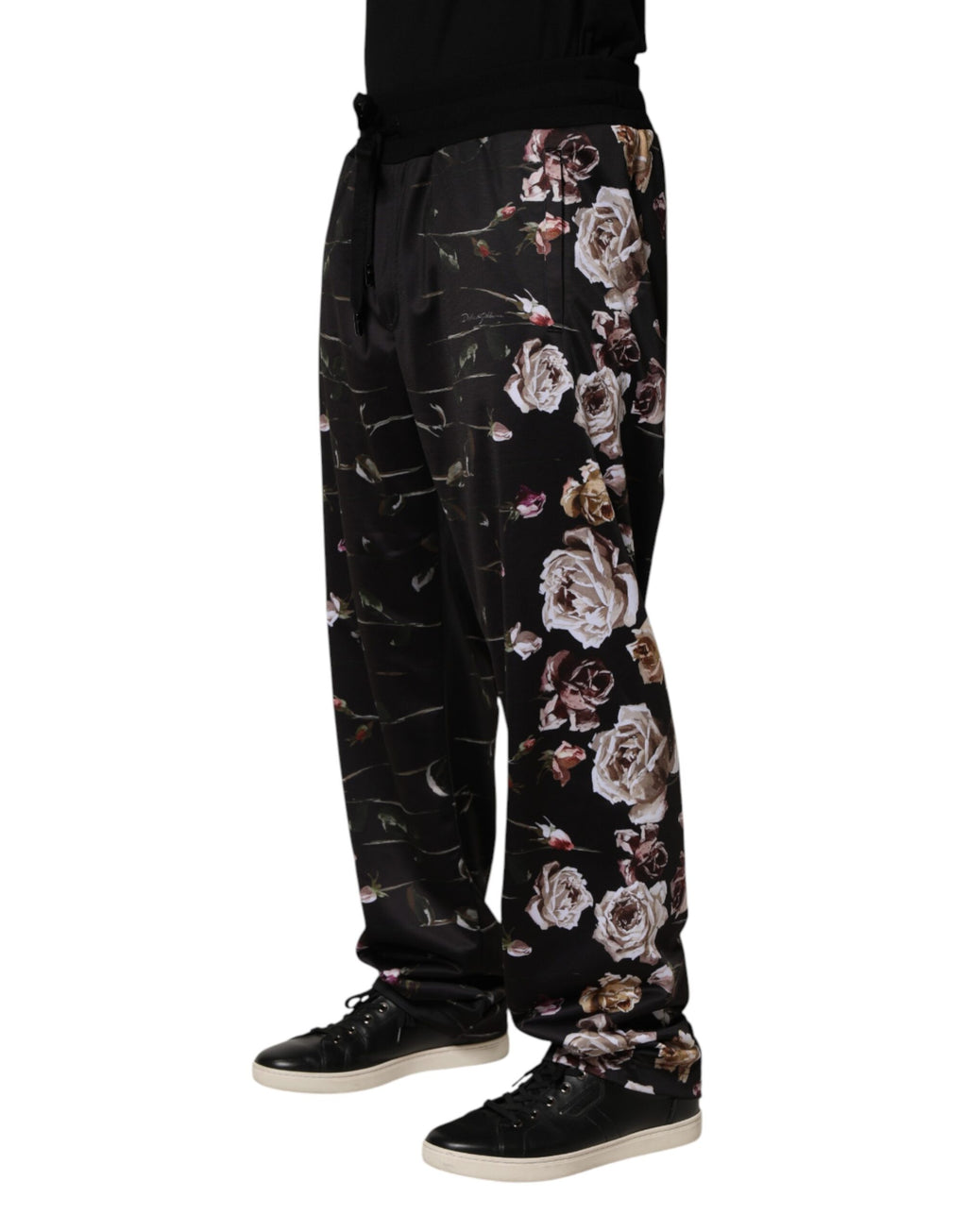 Pantalon chino droit noir Dolce & Gabbana avec motif floral, style élégant et coupe classique, visible en gros plan.