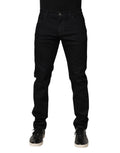 Jeans slim en denim noir à fleurs en coton de Dolce & Gabbana pour homme, détails floraux visibles sur le tissu.