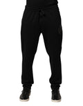 Pantalon slim en coton noir Dolce & Gabbana avec logo, style jogger, ajusté, avec ceinture élastique et poches latérales.