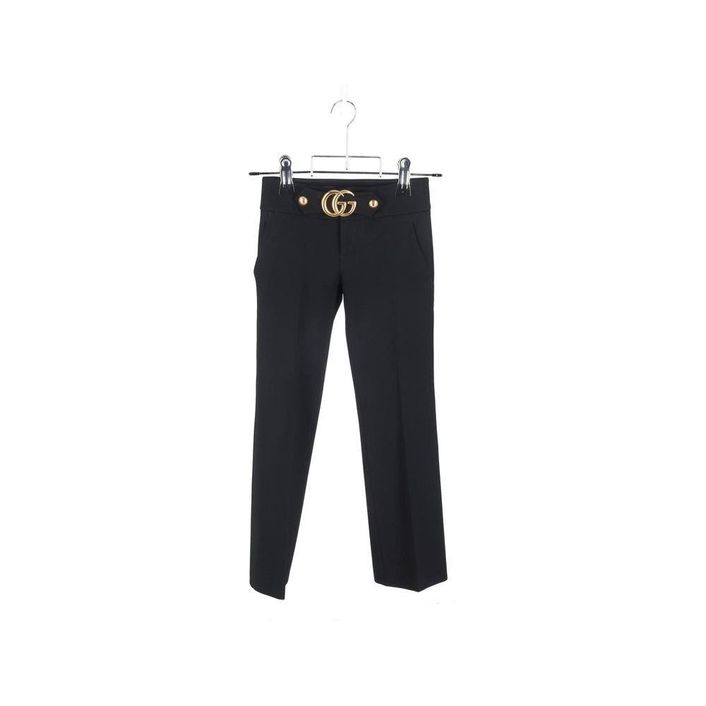Pantalon de costume noir en viscose Gucci pour homme, coupe élégante et tissu fluide, visible en détail dans l'image.