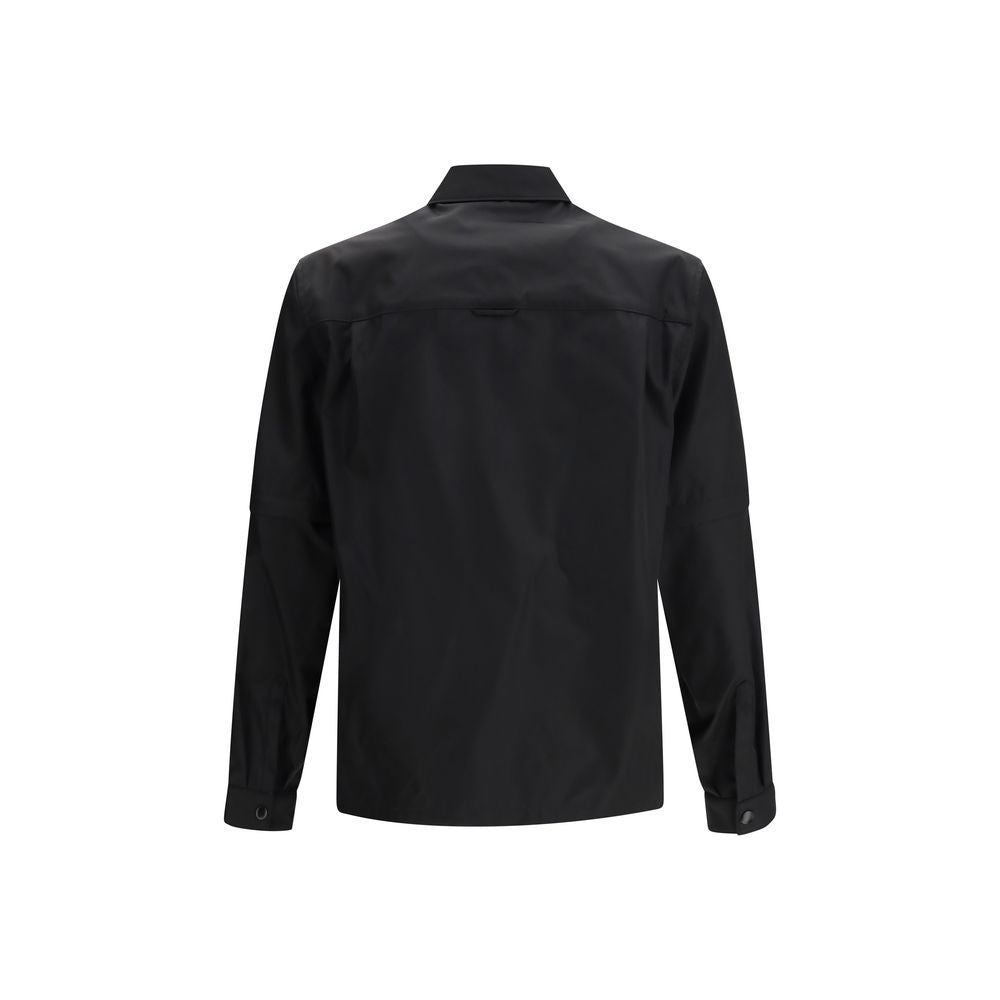 Veste Prada noire en polyamide recyclé, style élégant avec fermeture éclair et col montant, vue de face.