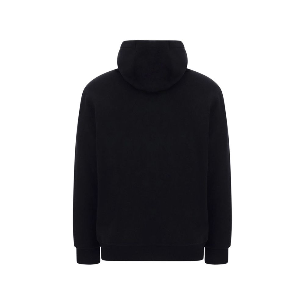 Sweat-shirt en coton noir Burberry, coupe décontractée avec logo emblématique, porté sur un mannequin, fond neutre.