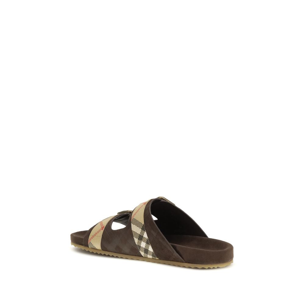 Sandales plates en cuir de veau brun Bos Taurus de Burberry, élégantes et confortables, pour un look sophistiqué.