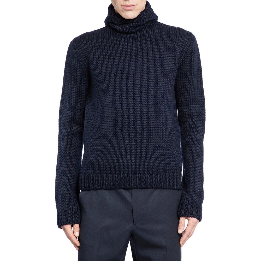 Pull en laine bleue Prada avec col roulé, détails élégants, porté sur mannequin, fond blanc.