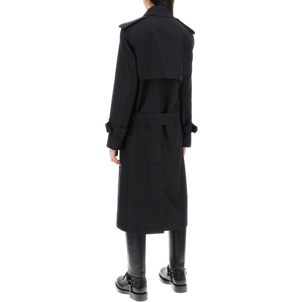 Manteau en polyester noir de Burberry, coupe élégante, porté sur un mannequin, détails de couture visibles.