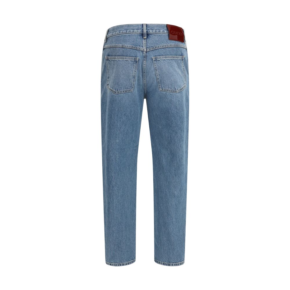 Jeans slim en coton bleu de Gucci, ajustés, avec détails modernes et logo discret, vue de face.