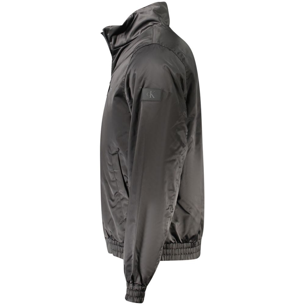 Veste noire pour homme en polyester de la marque Calvin Klein, visible en détail sur l'image.