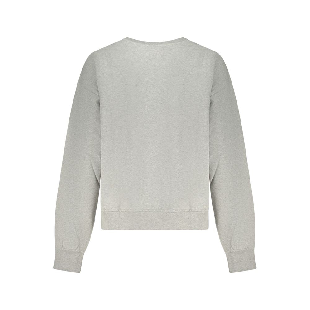 Sweat-shirt femme en coton gris de Calvin Klein, ajusté, avec logo discret sur la poitrine, porté par une mannequin.