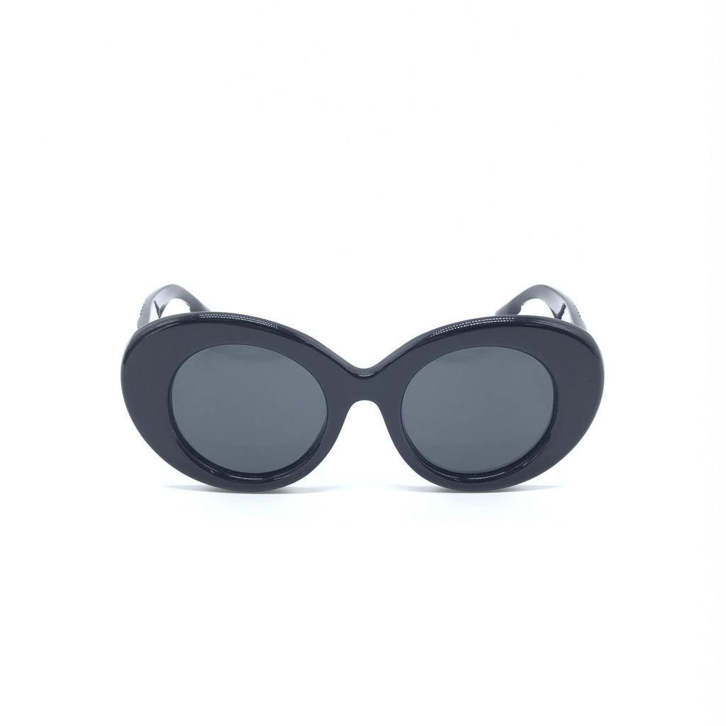 Lunettes de soleil noires oversize de forme ronde de Burberry, avec monture épaisse et logo visible.
