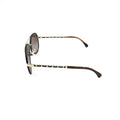 Lunettes de soleil aviateur Chanel dorées et noires avec verres polarisés, style élégant et tendance.