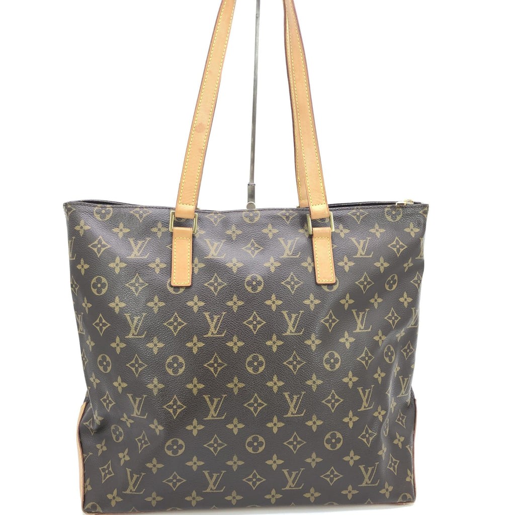 Sac cabas Louis Vuitton Monogram Mezzo, grand sac à main en toile avec logo emblématique, porté avec des poignées en cuir.