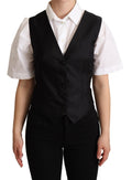 Veste sans manches en soie noire Dolce & Gabbana, ajustée à la taille, élégante et sophistiquée.