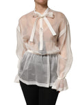 Blouse en soie blanche transparente avec nœud en dentelle Dolce & Gabbana, haut élégant et féminin.