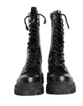 Bottes de combat en cuir noir Dolce & Gabbana avec semelle trekking, style robuste et tendance, vue de face.