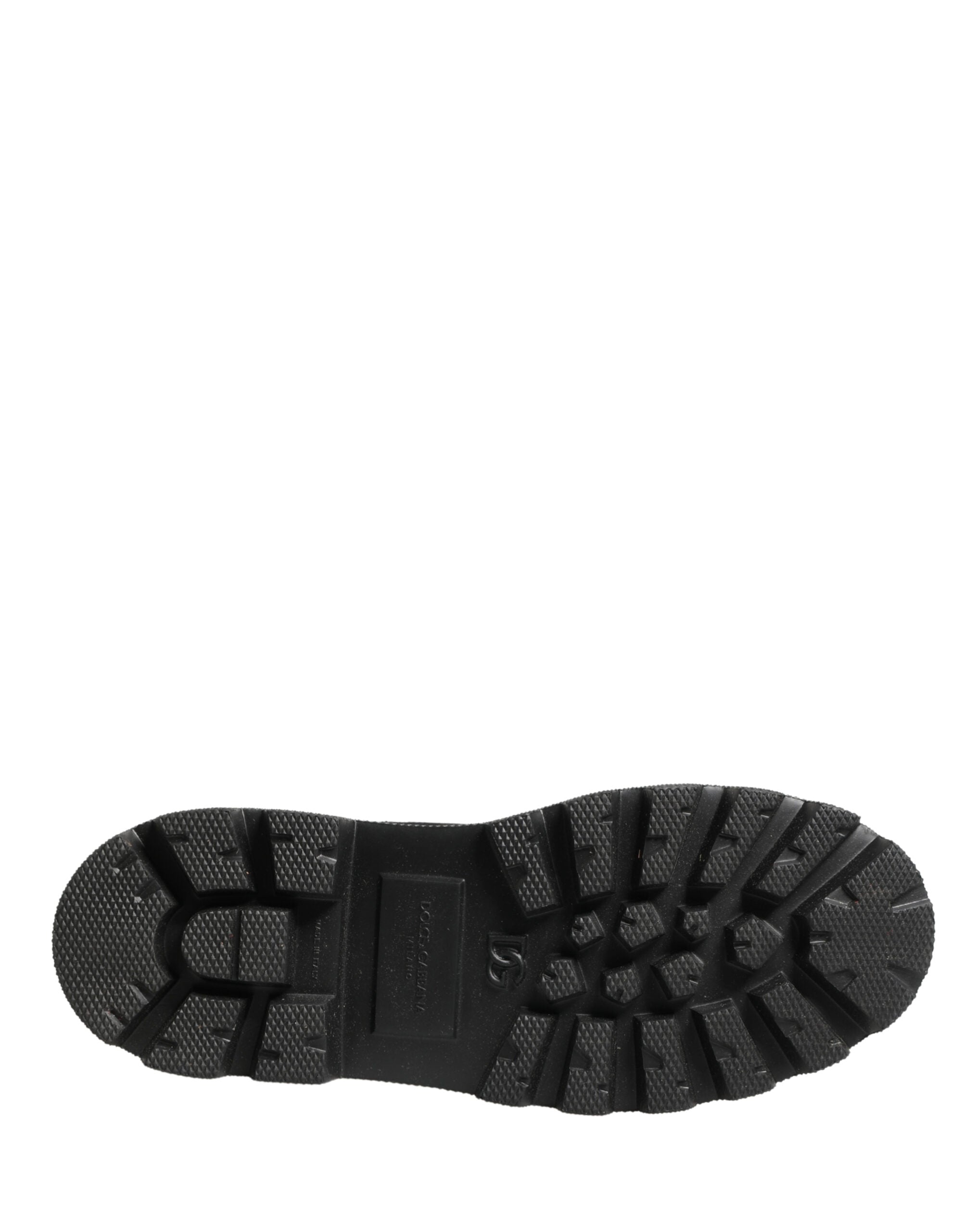 Bottes de combat en cuir noir Dolce & Gabbana avec semelle trekking, style robuste et moderne, visibles sur l'image.