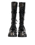 Bottes combat en cuir noir Dolce & Gabbana, hautes jusqu'au genou, avec semelle robuste et style élégant.