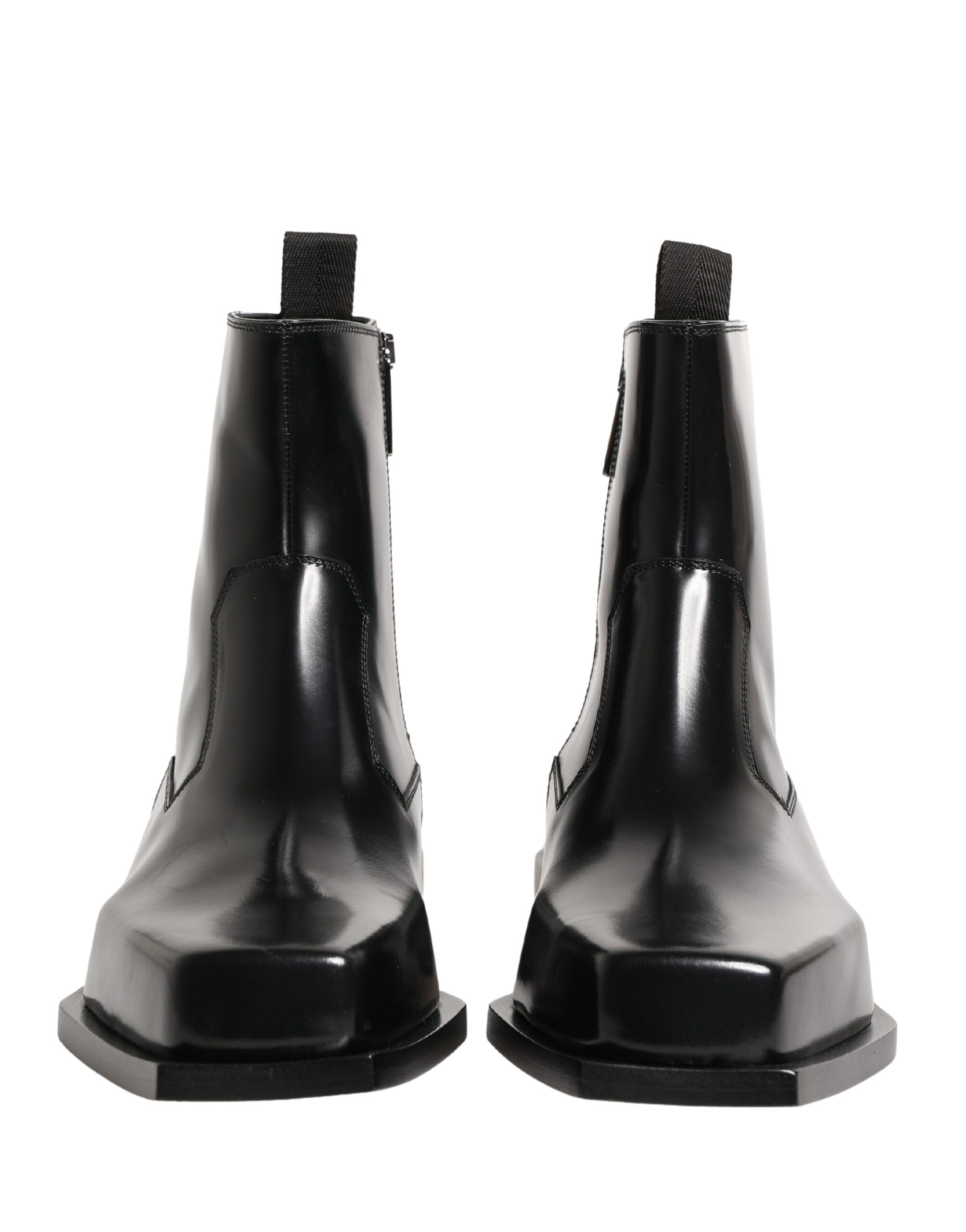 Bottines en cuir noir Dolce & Gabbana avec fermeture éclair et semelle en talon, style élégant et moderne.