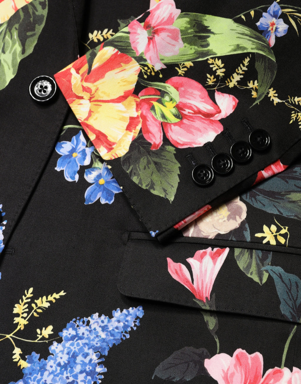 Costume deux pièces noir Dolce & Gabbana avec motif floral, veste à double boutonnage et pantalon, style élégant et sophistiqué.