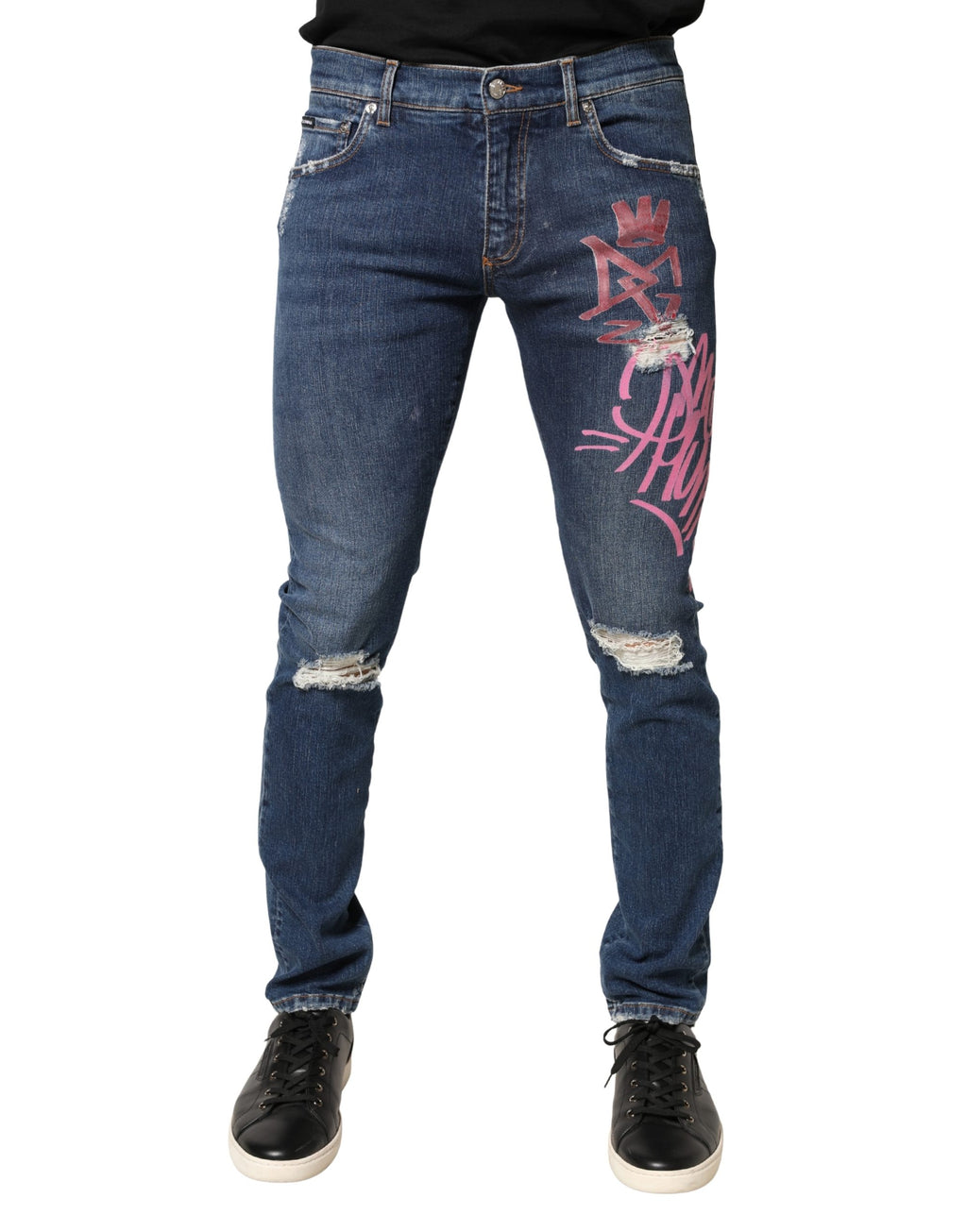 Jeans skinny Dolce & Gabbana en denim bleu avec motif graffiti déchiré et style distressed.