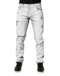Jeans homme Dolce & Gabbana gris clair, skinny déchirés en denim avec détails usés, style élégant et tendance.