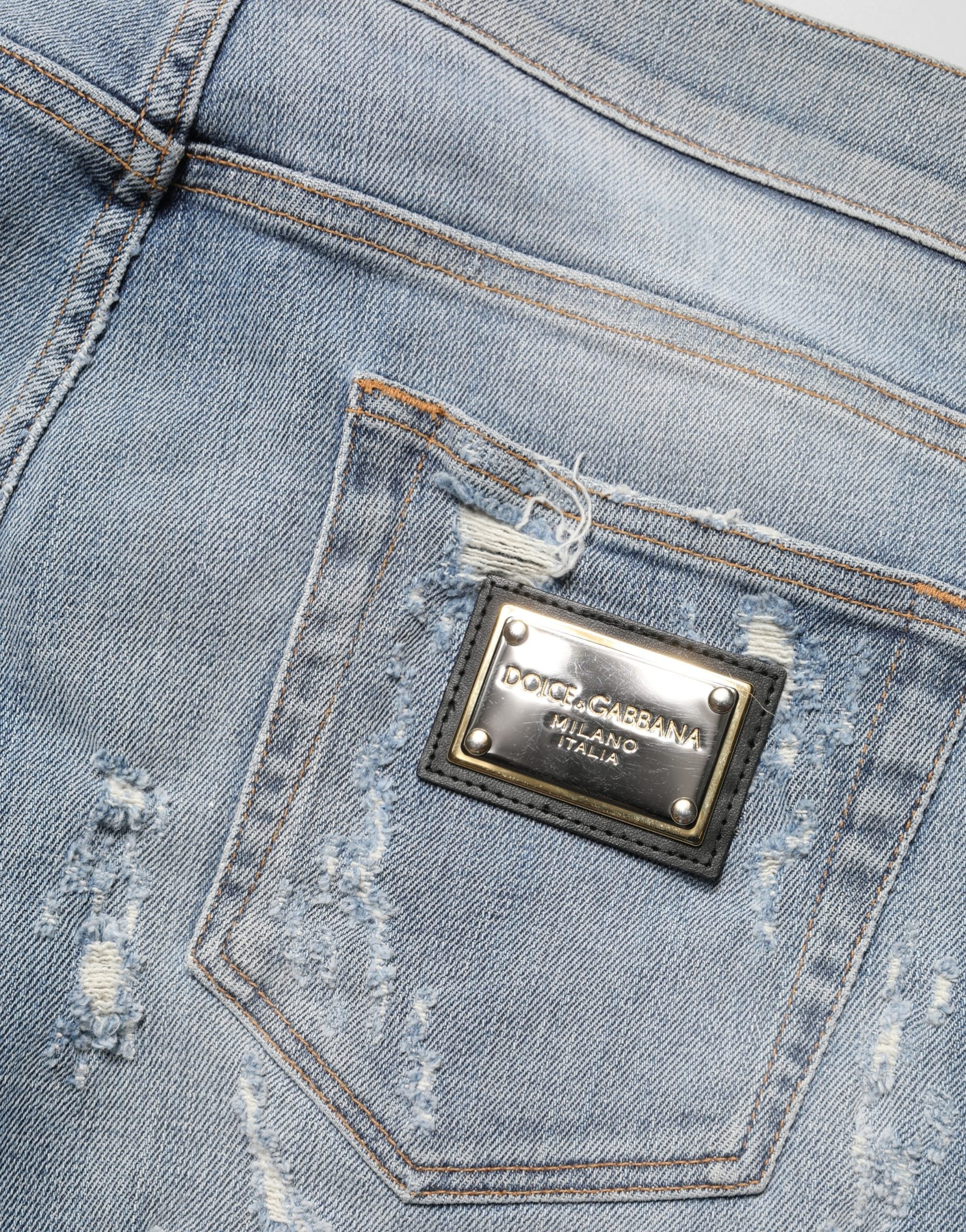 Jeans skinny déchirés pour homme Dolce & Gabbana Light Blue, denim bleu clair avec détails usés et style moderne.