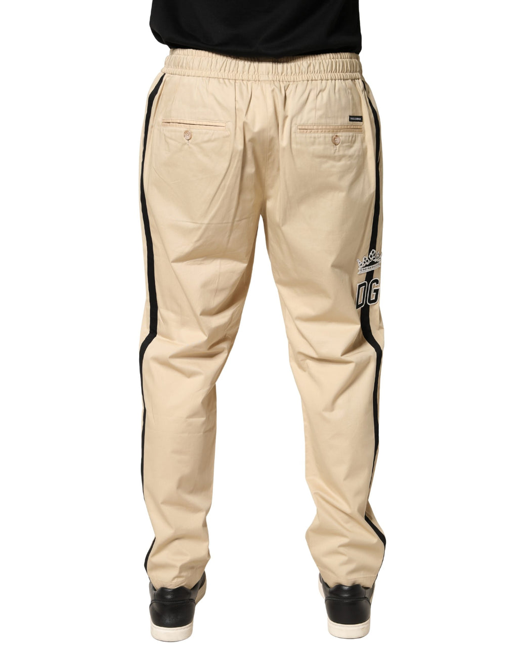 Pantalon jogger skinny en coton beige pour homme de la marque Dolce & Gabbana, vue de face.