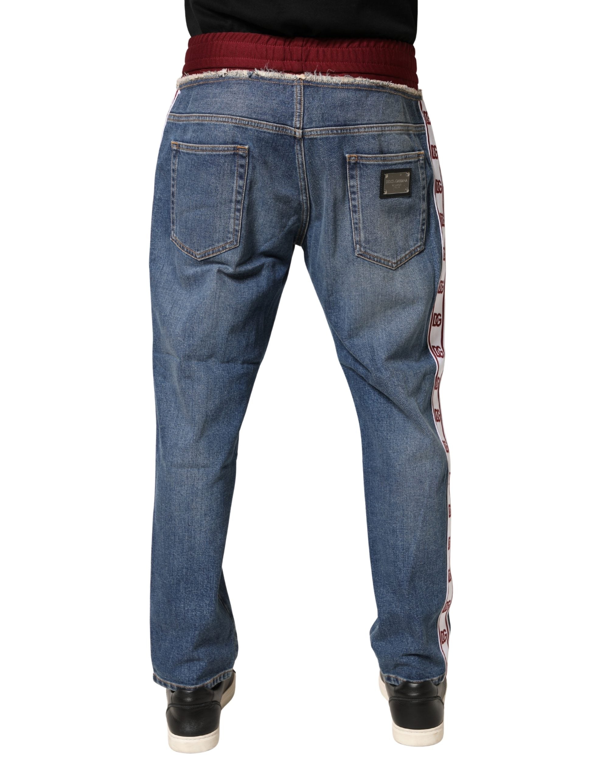 Jean droit en denim bleu en coton Dolce & Gabbana avec cordon de serrage, visible en détail dans l'image.
