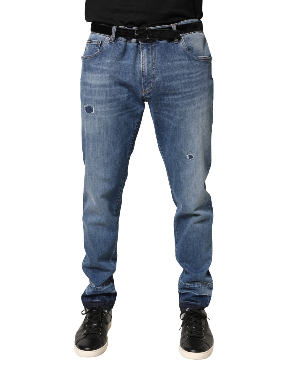 Jeans skinny en denim de coton bleu déchiré de Dolce & Gabbana, style tattered et tendance, visible sur l'image.
