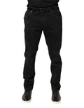 Jean skinny en coton déchiré noir de Dolce & Gabbana, style tattered, avec détails usés et coupe ajustée.