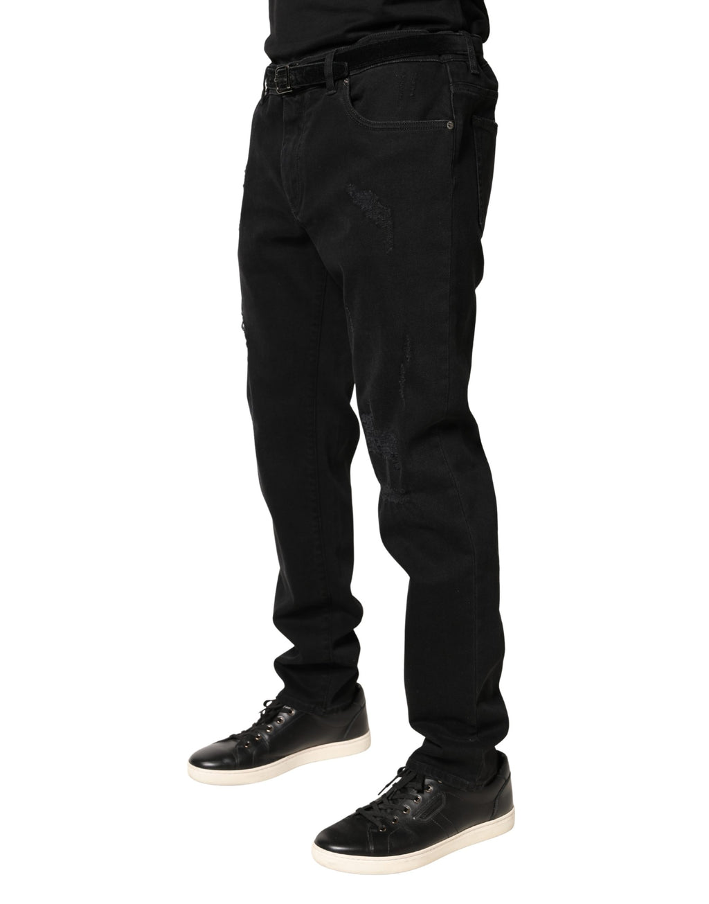 Jeans skinny en denim coton noir tacheté de Dolce & Gabbana, style déchiré et tendance, visibles en détail dans l'image.