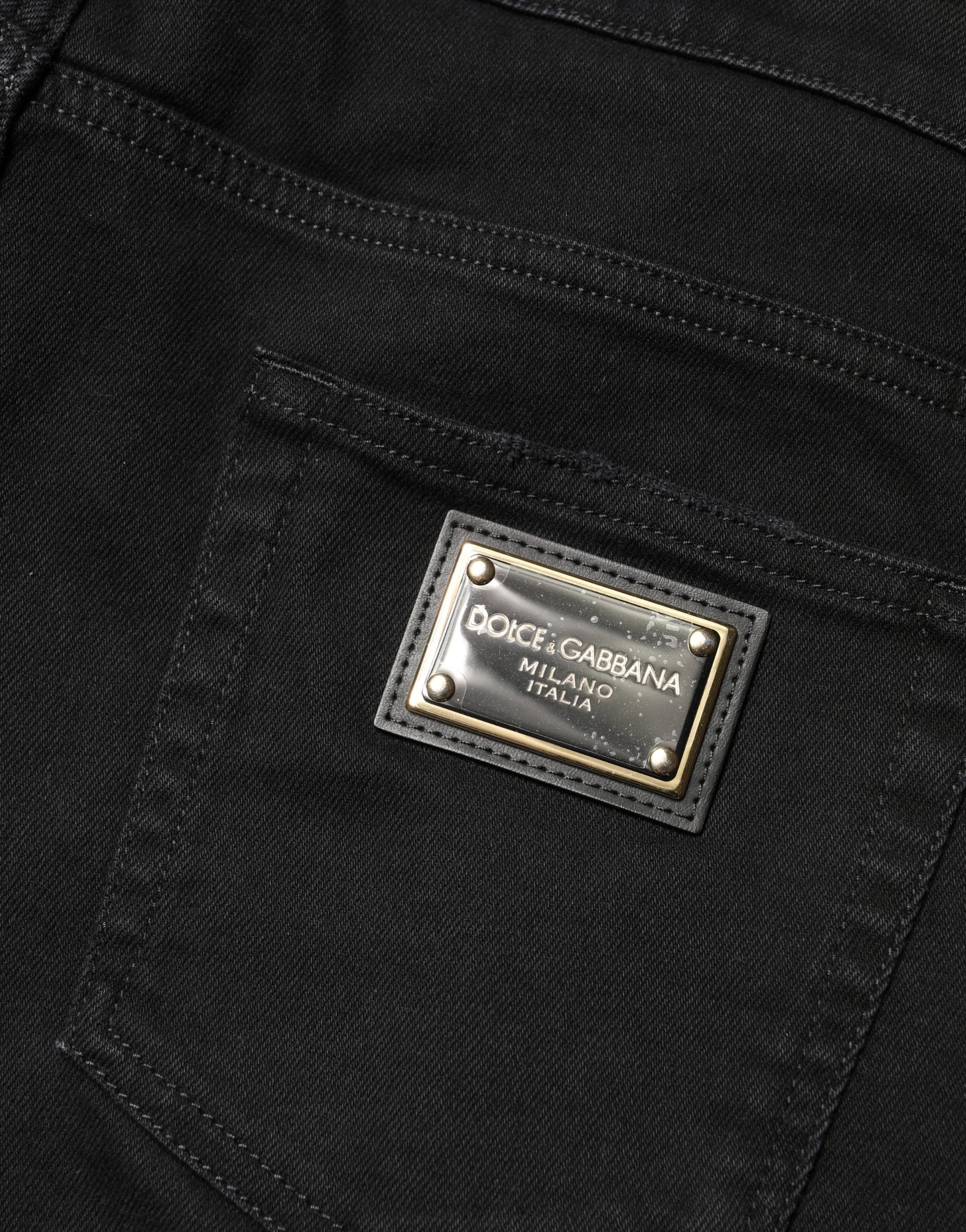Jeans skinny en coton déchiré noir de Dolce & Gabbana, style décontracté avec détails usés et coupe ajustée.
