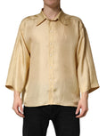 Chemise homme oversize en soie jaune Dolce & Gabbana avec boutons, vue de face, détails du tissu et style élégant visible.