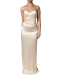Robe longue blanche en satin sans bretelles de la marque Dolce & Gabbana, élégante et sophistiquée, portée sur un mannequin.