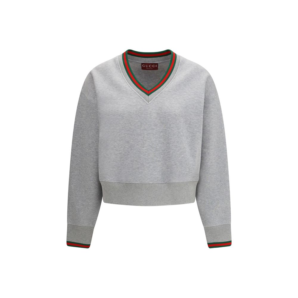 Sweat-shirt gris en coton de Gucci, vêtement décontracté avec logo Gucci visible, porté par un mannequin.