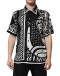 Chemise Dolce & Gabbana en soie noire avec logo imprimé et manches courtes, vue de face.