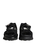 Sandales hommes Dolce & Gabbana noires à logo détaillé, chaussures épaisses et tendance, visibles en gros plan.