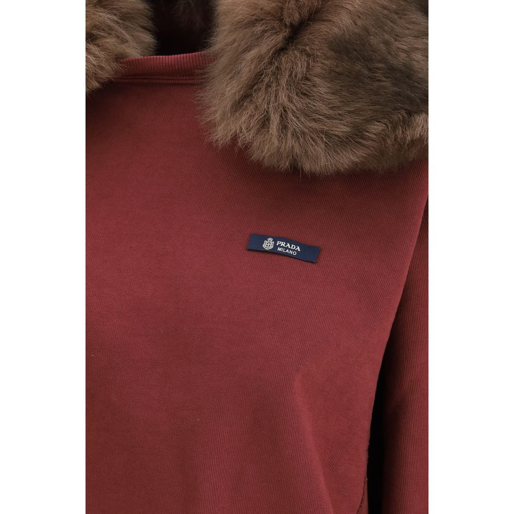 Sweatshirt en coton Bordeaux de Prada, coupe décontractée, logo Prada visible sur la poitrine, portée sur un mannequin.