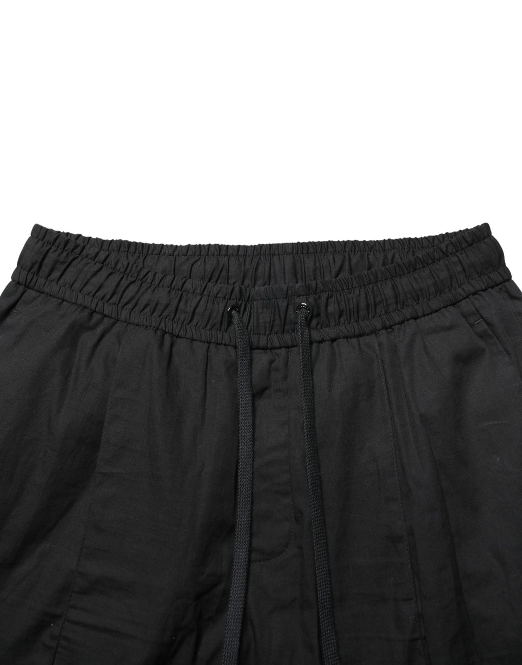 Pantalon jogger skinny noir en coton de la marque Dolce & Gabbana pour homme, vue de face.