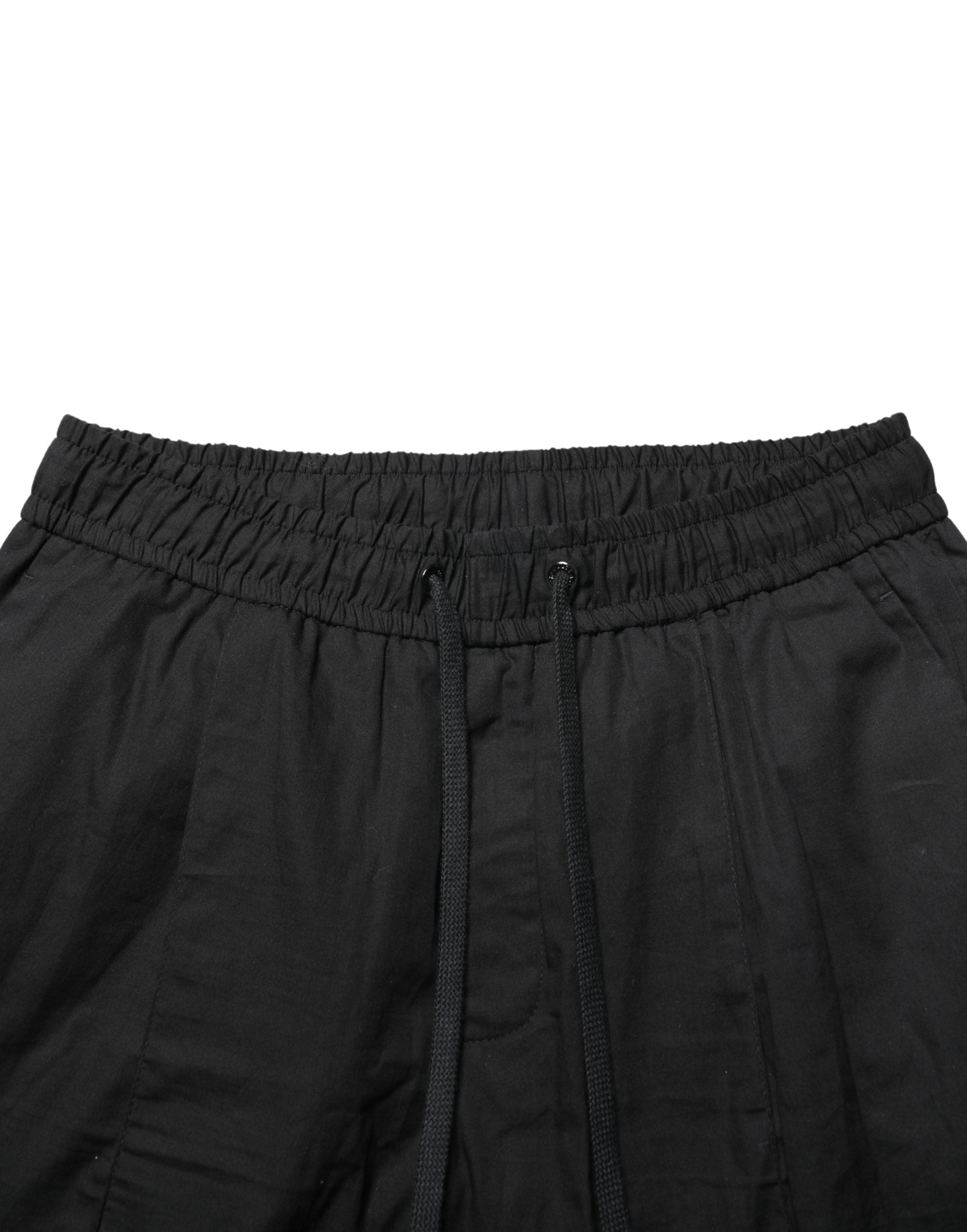 Pantalon jogger skinny noir en coton de la marque Dolce & Gabbana pour homme, vue de face.