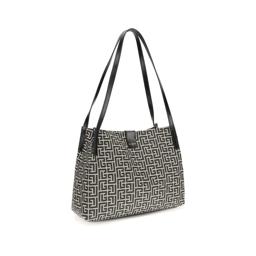Sac à bandoulière en coton noir de Balmain, avec détails élégants et design moderne visible sur l'image.