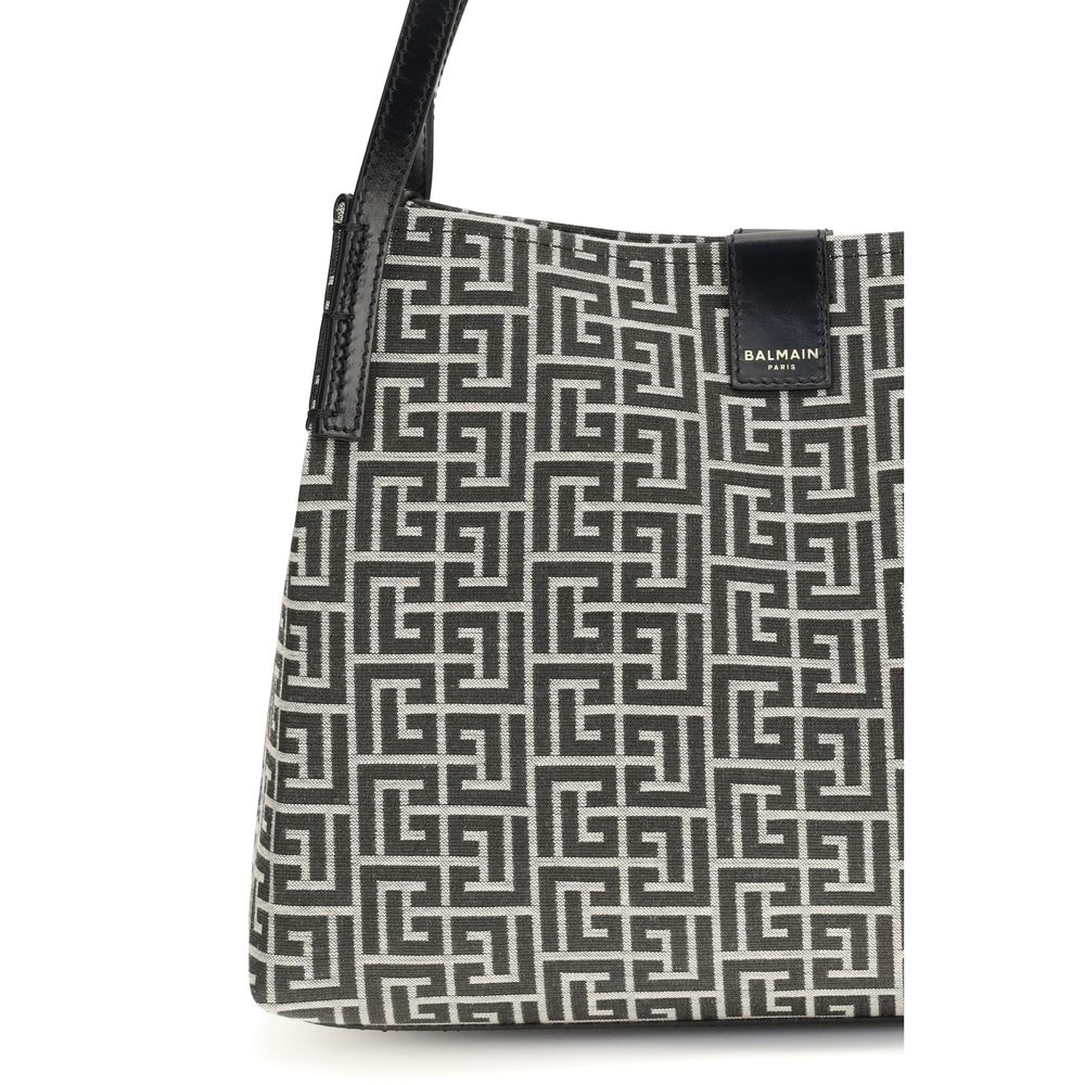 Sac à épaule noir en coton Balmain, élégant et tendance, avec détails de luxe visibles sur l'image.