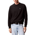 Sweat-shirt noir en coton de Calvin Klein Jeans, coupe classique avec logo discret, porté en mode décontracté.