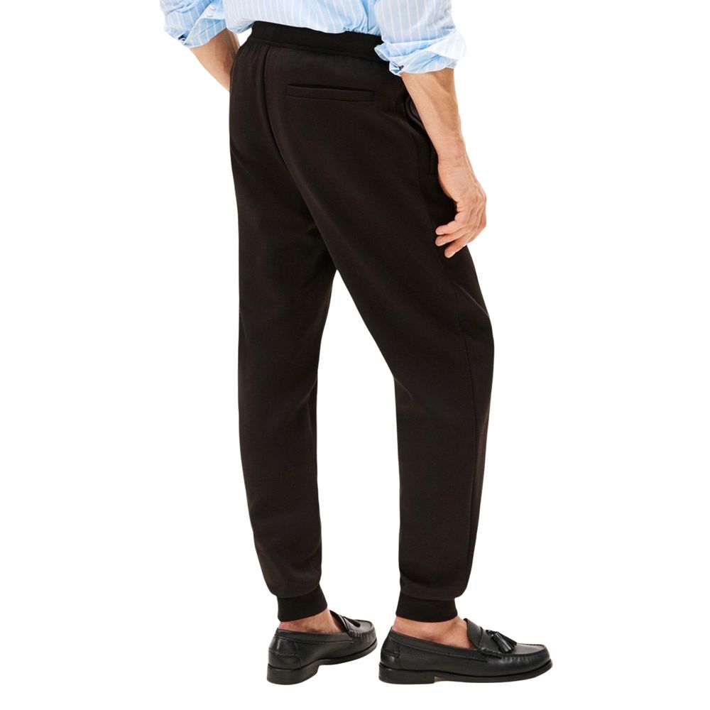 Pantalons de jogging en coton noir Tommy Hilfiger pour l'entraînement, avec logo discret sur la jambe droite.