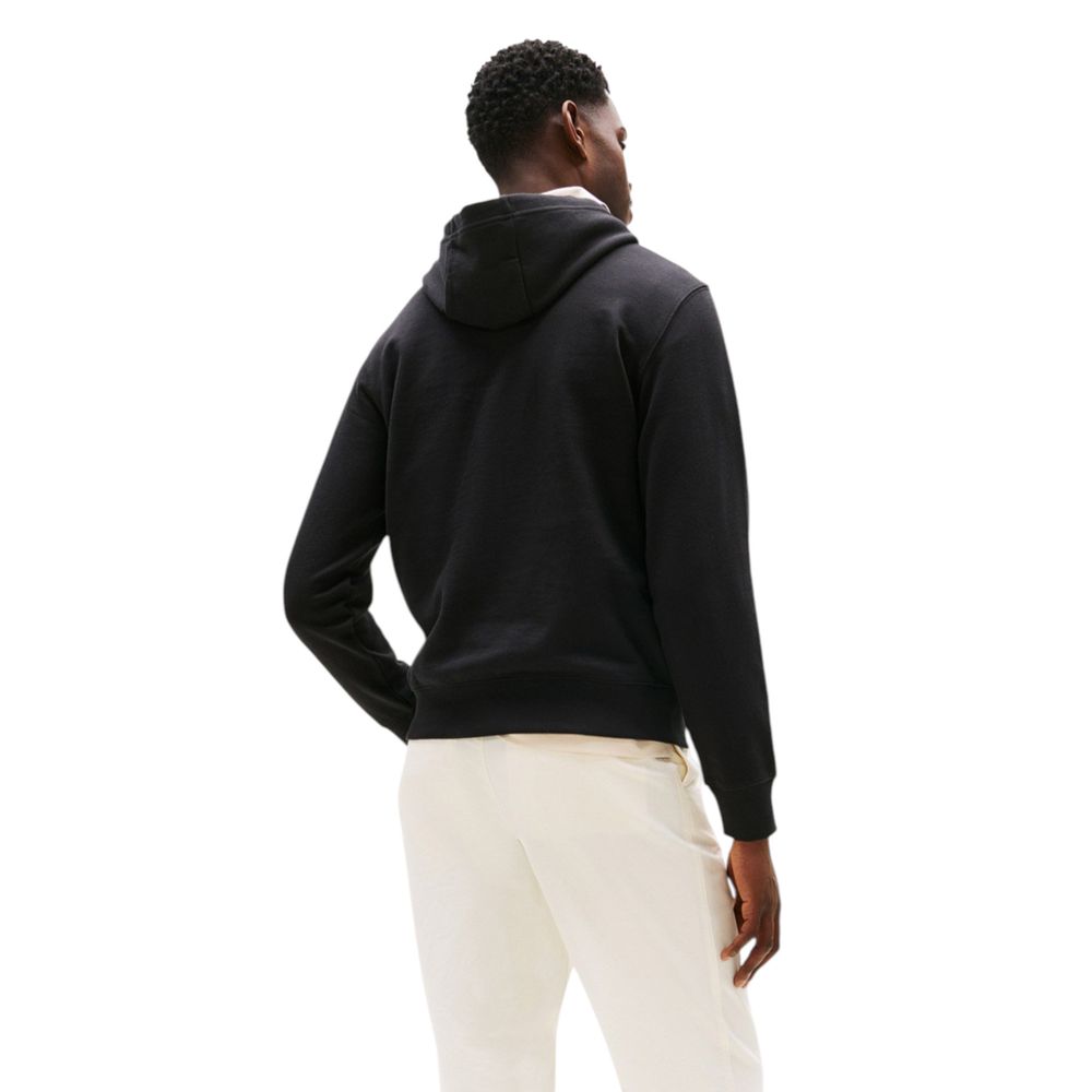 Sweat à capuche Tommy Hilfiger en coton recyclé noir, avec logo visible sur la poitrine et couture décontractée.