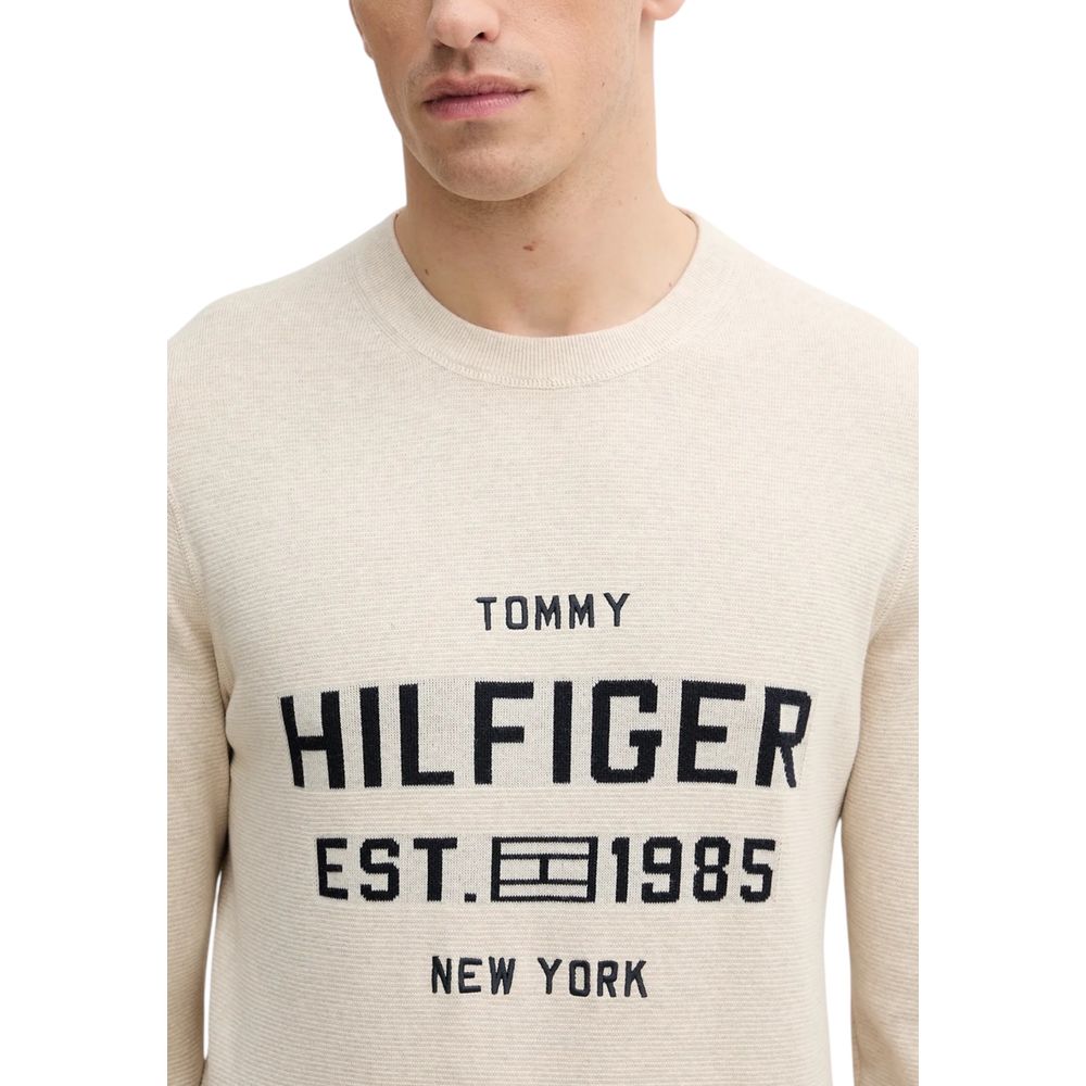 Sweatshirt beige en coton biologique de Tommy Hilfiger, à col rond et manches longues, porté sur un mannequin.